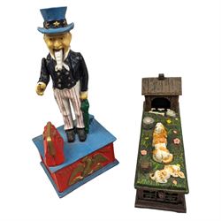 Two Reproduction cast metal money banks, one modelled as 'Uncle Sam', the other as a dog and kennel, tallest H27cm