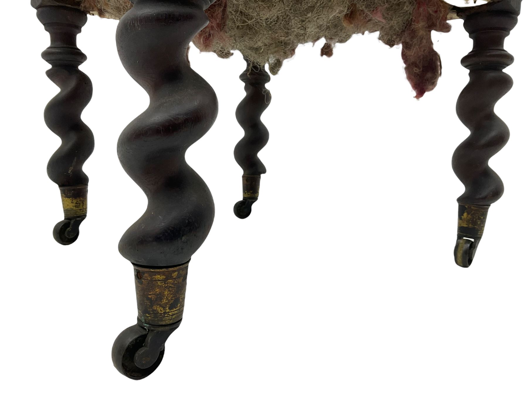 Victorian oak and wrought metal Gothic open armchair, the pointed arched back carved with foliate, cusped inner arch upholstered in red, spiral turned uprights and supports, with arms made of spiral forged metal