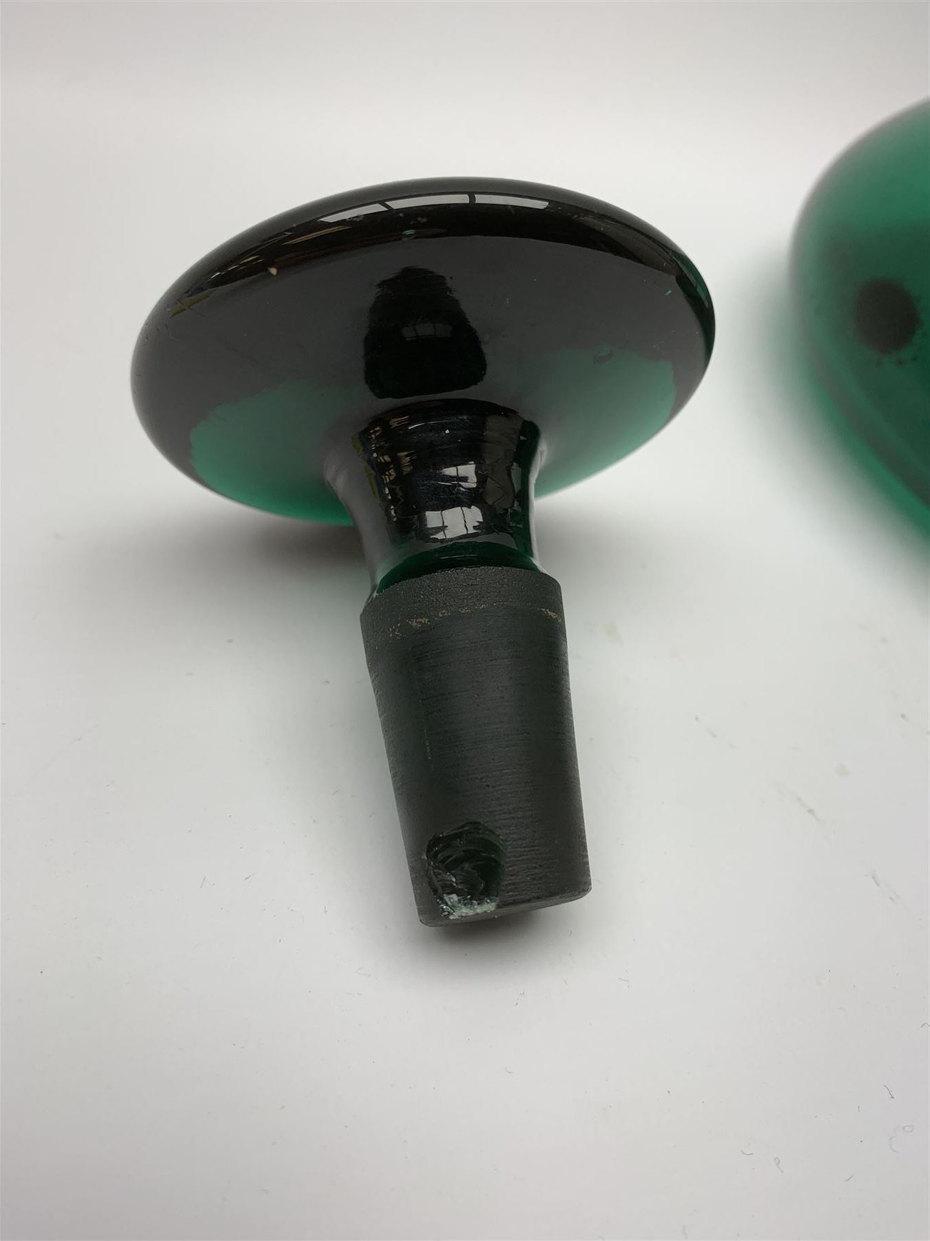 19th century green glass ships decanter with flat topped stopper, H21.5cm, together with a set of four 19th century green glass wine glasses, the funnel bowls upon bladed knopped stems and circular feet, H13cm