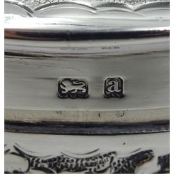 Victorian silver lidded trinket box, with embossed decoration by John Edward Wilmot, Birmingham 1900, silver bladed knife and fork with mother of pearl handles by Atkin Brothers, Sheffield 1862 and an embossed silver dish hallmarked (4)