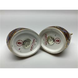 Two Royal Crown Derby Goldfinch Nesting paperweights with silver stoppers, together with two Royal Crown Derby imari pin dishes, largest dish D13cm