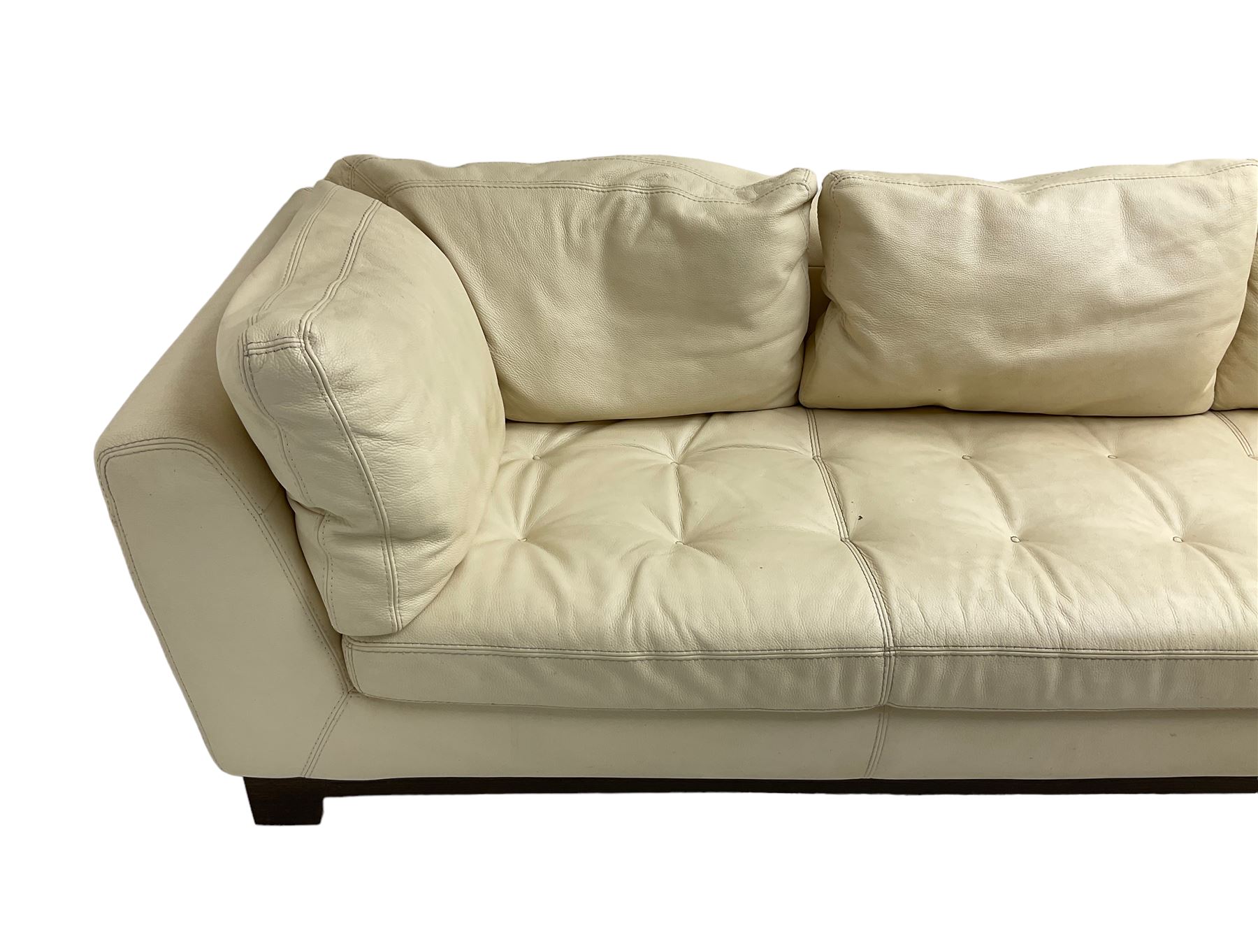 Roche-Bobois - large corner sofa, upholstered in ivory leather with buttoned seat cushions, raised on a stained beech base with bracket feet