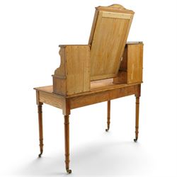 Late Victorian figured pitch pine dressing table, the rectangular swing mirror with shaped cresting flanked by mirrored superstructures, one with a three-quarter galleried shelf, fitted with two drawers, rectangular over two frieze drawers fitted with pierced brass lattice handle plates, raised on ring-turned tapering legs with brass castors