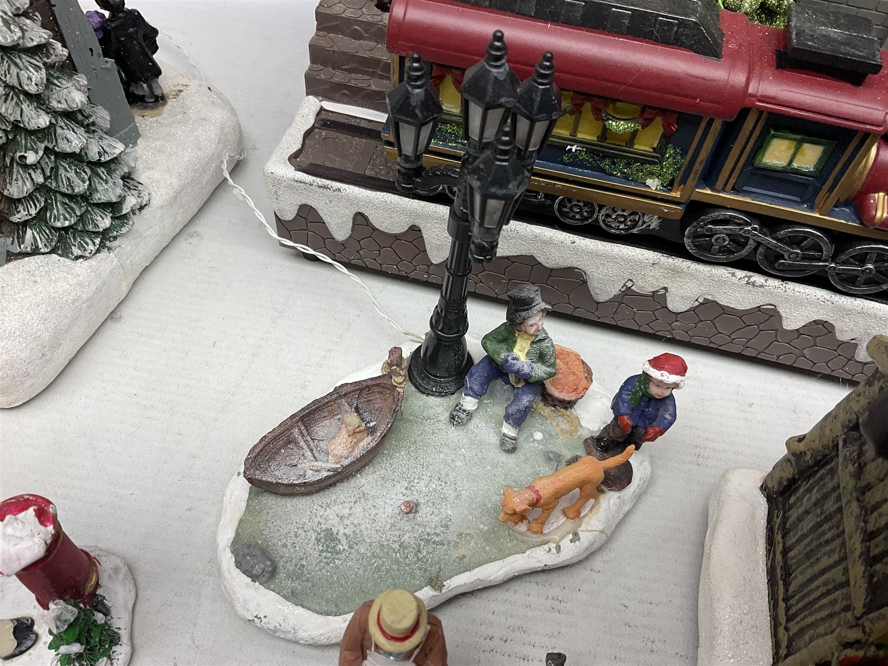 Christmas decorations; Premier LED Christmas Village scene with moving train, together with three Lumineo christmas scenes, and other similar 
