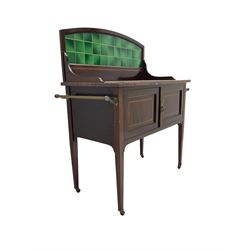 Edwardian inlaid mahogany washstand, raised back with emerald green tiles over marble top, fitted with two panelled cupboard doors, raised on square tapering supports on ceramic castors