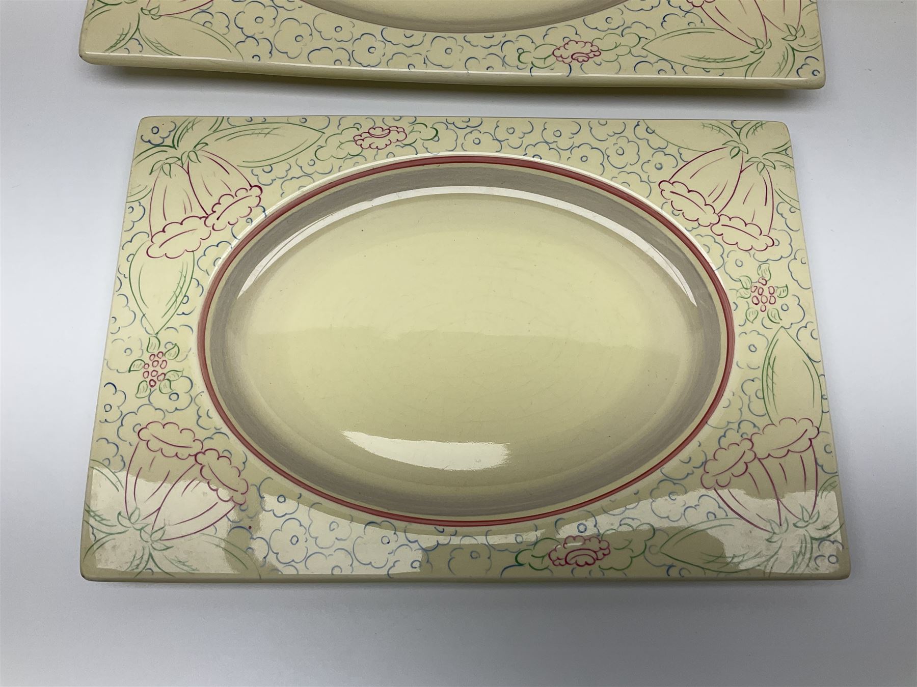 Clarice Cliff Biarritz part dinner set, circa 1930, for Royal Staffordshire, of rectangular form, decorated with bluebells, to include one serving plate, six dinner plates, three side plates, etc, printed mark beneath with reg no 784849 (17)