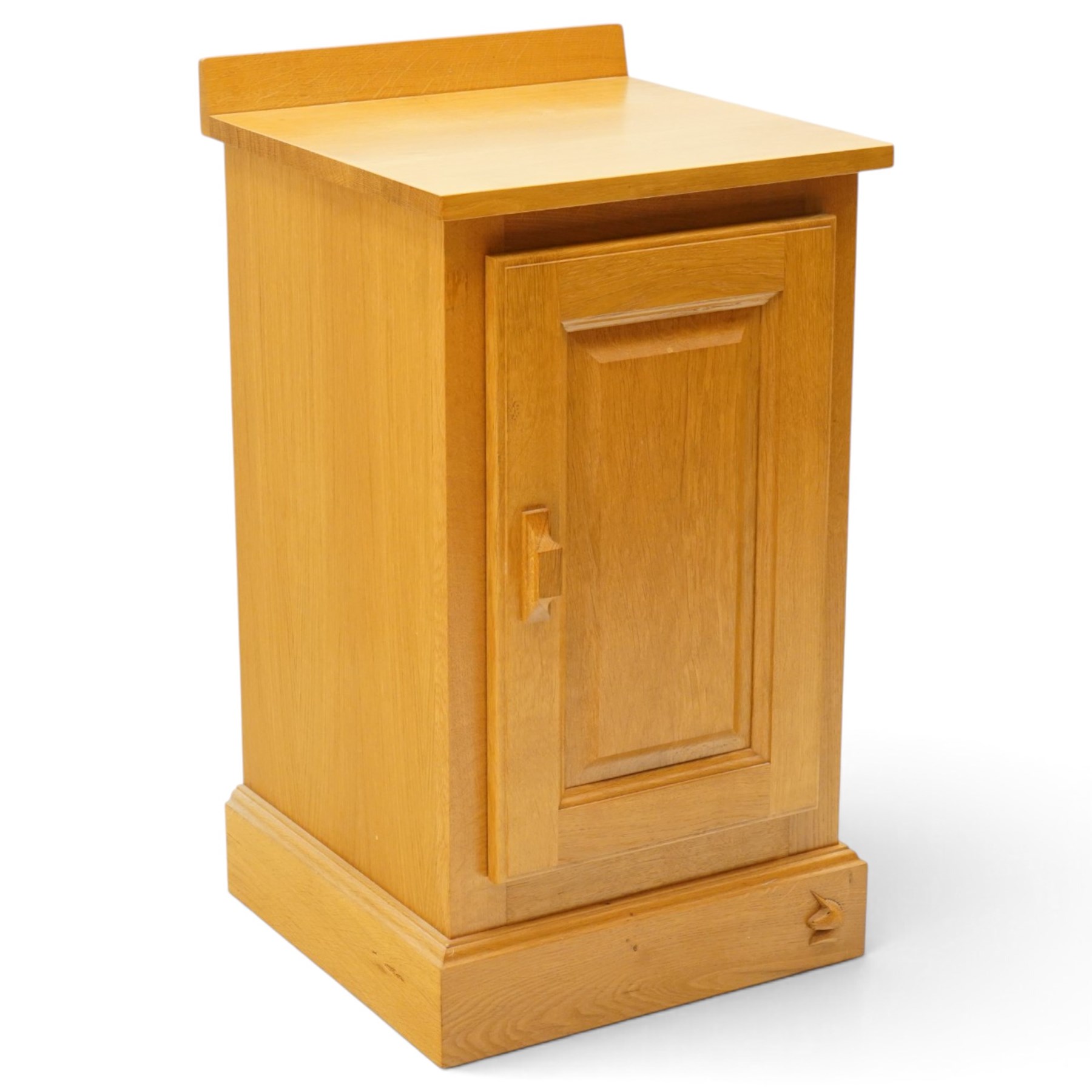 Unicornman - craftsman made oak bedside cupboard, raised back over panelled cupboard, on skirted base applied with carved unicorn signature, by Geoff Gell of Coxwold