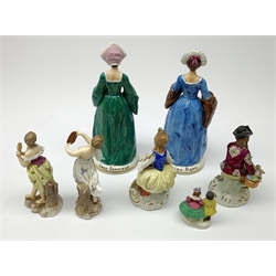 Four Sitzendorf figurines, comprising two examples modelled as two of Henry VIII's wives, a smaller pair modelled as seated male and female figures, plus two Continental examples modelled as classical female figures, etc. (7). 