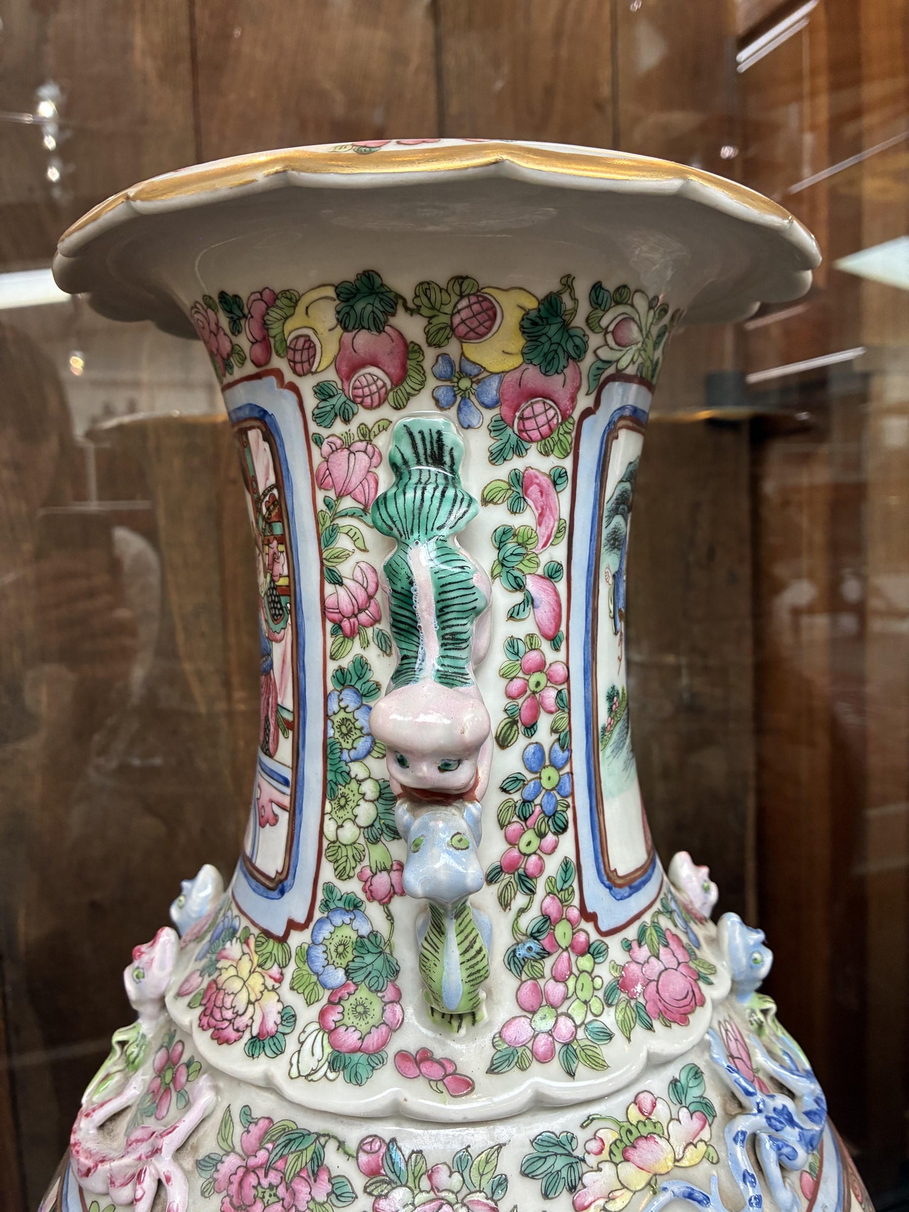 Large pair of 19th century Cantonese famille rose vases, each painted with various courtly scenes, including a display of warriors fighting on horseback before an official and his attendants, double Buddhist lion handles and applied at the shoulders with chilong, the lower band painted with Greek key motif, H58cm (2)