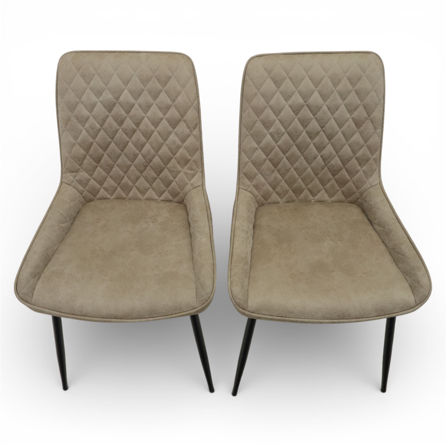 Next Home - ‘Monza’ design set of four dining chairs, upholstered in mink-toned faux leather with diamond quilted backs and plain padded seats, shaped backs with integrated side wings, raised on black painted tapering metal supports