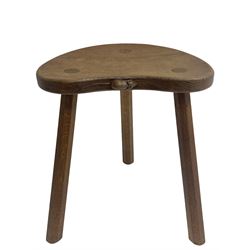 'Mouseman' oak three-legged stool, kidney shaped dished seat carved with mouse signature to edge, by Robert Thomas of Kilburn