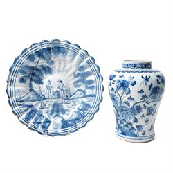 18th century Dutch Delft plate of fluted design decorated in blue and white with figures i...