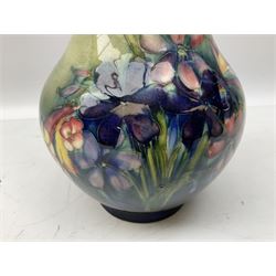 Moorcroft vase of baluster form decorated in the Spring Flowers pattern upon a merging green and blue ground, with impressed and painted marks beneath, H22.5cm