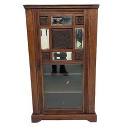Edwardian walnut sheet music cabinet, the glazed door with floral carved panels and sectional bevel glazed mirrors enclosing four shelves
