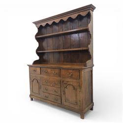 Georgian design oak dresser, the raised plate rack with shaped sides and two open shelves, upon a dresser base fitted with six drawers and two cupboard doors, and short block feet 