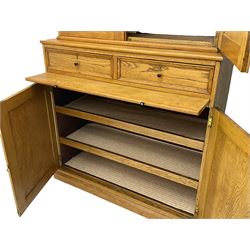 Early to mid-20th century light oak secretaire office cabinet, cupboard enclosed by two panelled doors over two drawers and slide, the lower section fitted with two shelves and enclosed by two panelled doors