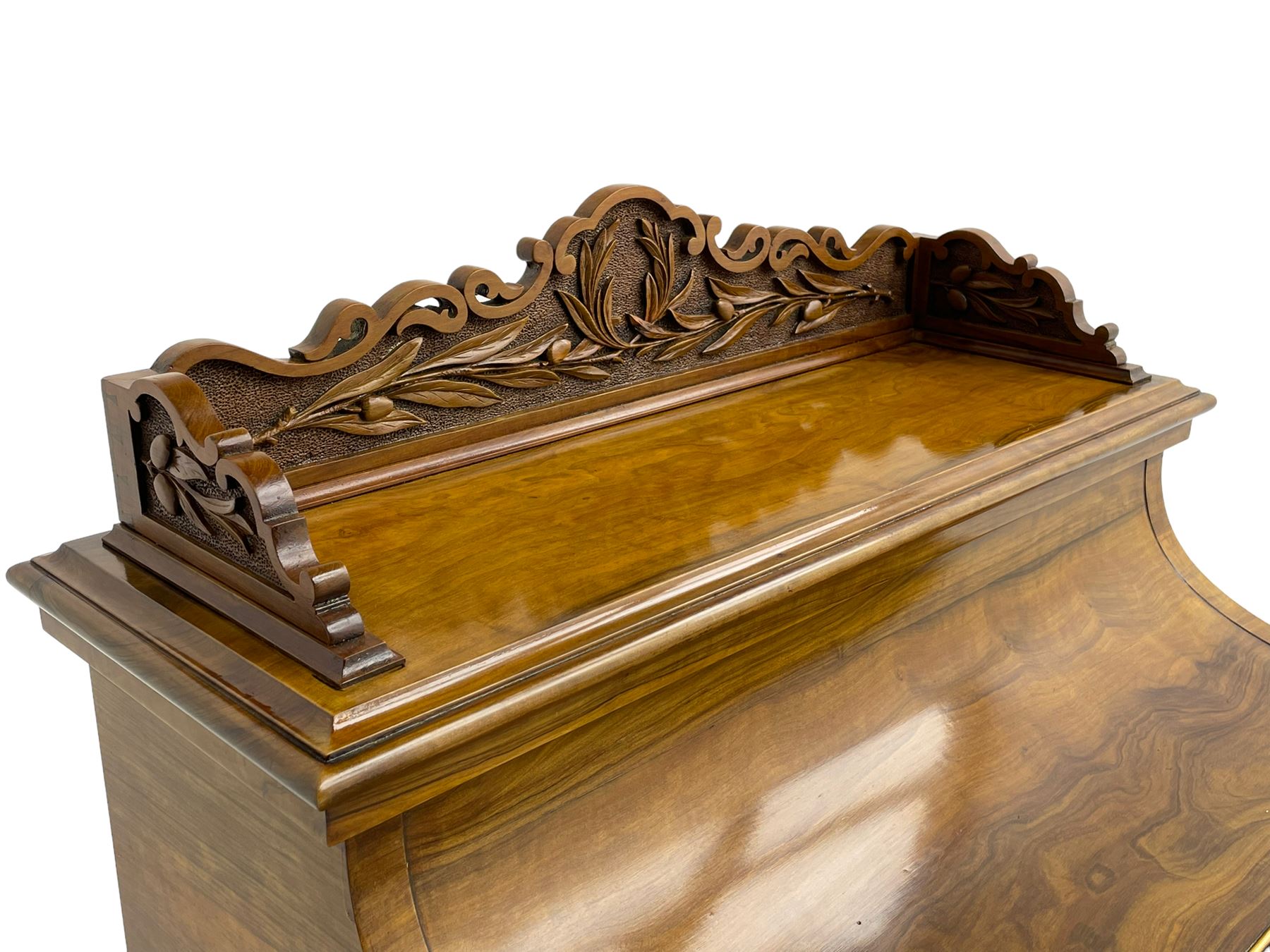 Fine and unusual 19th century olivewood piano top davenport, raised shaped back carved with olive branches and olives, the top hinges to reveal lidded and correspondence compartments, the piano lid enclosing sliding top with hinged and adjustable writing surface with leather inset, right-hand panelled door enclosing four drawers, olive branch and scroll carved cabriole front supports on moulded and shaped platform, turned cup feet with recessed castors 