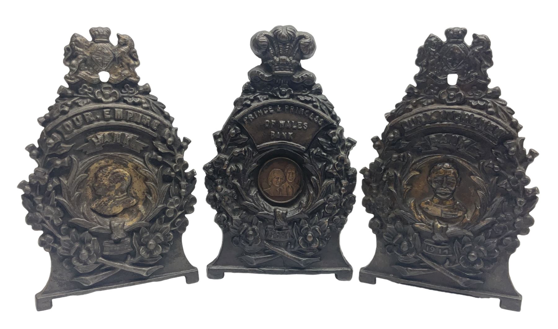 Two early 20th century cast-iron money banks - 'Our Kitchener Bank' c1914 H17cm and 'Our Empire Bank' c1911 depicting George V and Queen Mary H17cm; both by Sydenham & McCoustra; and another similar for The Prince & Princess of Wales 1981 by Robert Brown (3)
