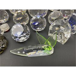 Swarovski Crystal paperweights, to include a globe with dove to the top, pyramid shapes etc, together with a large collection of boxes and stands  