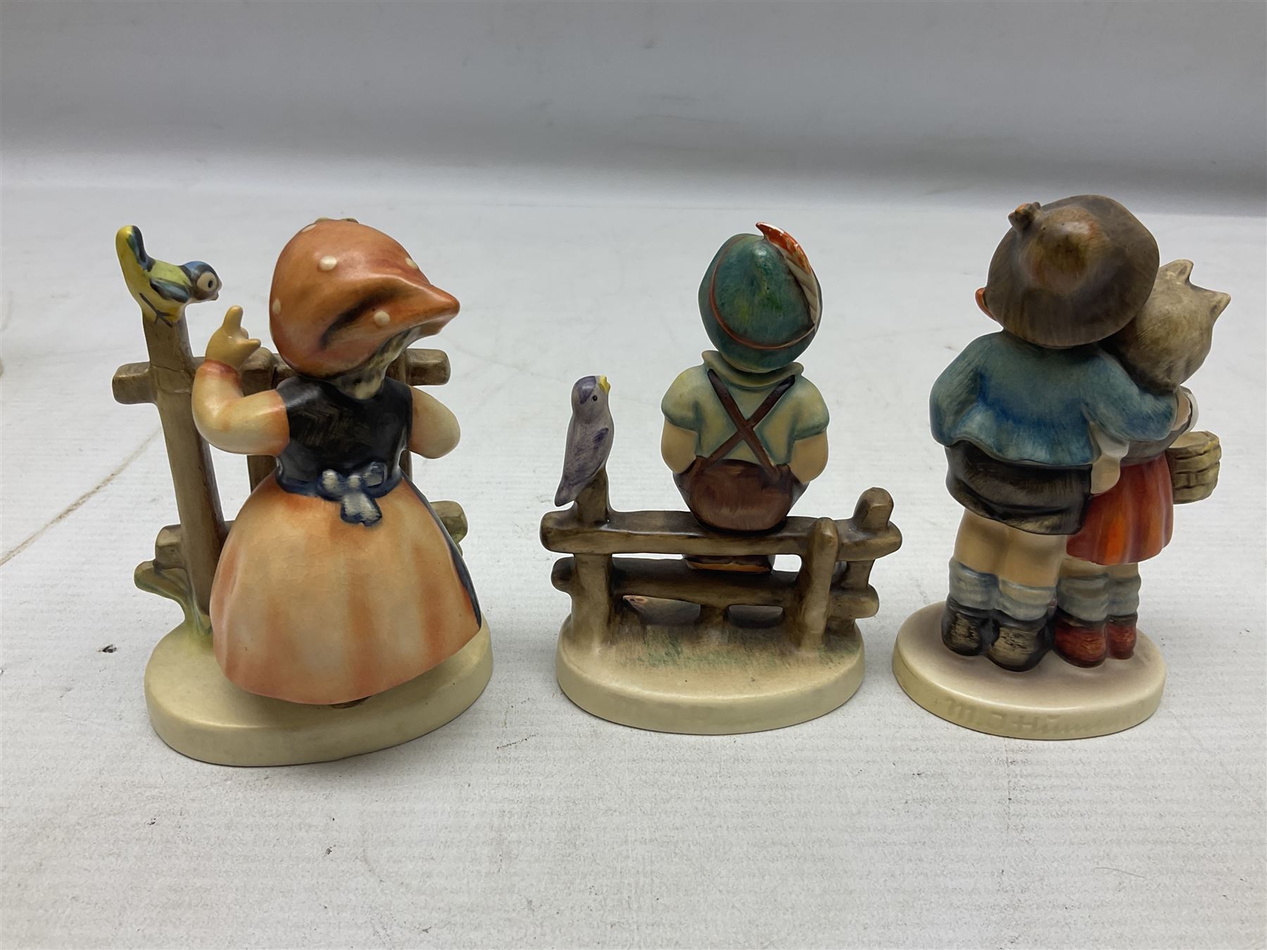 Seven Goebel Hummel figures, comprising Chimney Sweep 12/I, Apple Tree Girl 14/I, Apple Tree Boy,  Little Goat Herder 200/I, Surprise 94 3/0, Signs of Spring 203/20 and Wayside Harmony 111/30, tallest H15cm