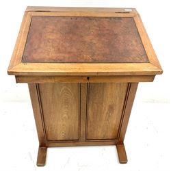 Early 20th century walnut davenport, sloped inset leather hinged lid, three side drawers, sledge supports 
