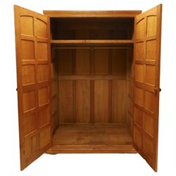 Beaverman - oak double wardrobe, enclosed by twin multi-panelled doors, Yorkshire Rose carved handles, the interior fitted with shelf and hanging rail, with signature carved beaver, by Colin Almack of Sutton, near Thirsk