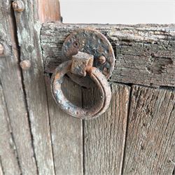 Pair of 19th century weathered wooden ecclesiastical church gates, the cresting rail over four pierced arches with slatted lower section, fitted with heavy cast iron hinges, latch and fittings