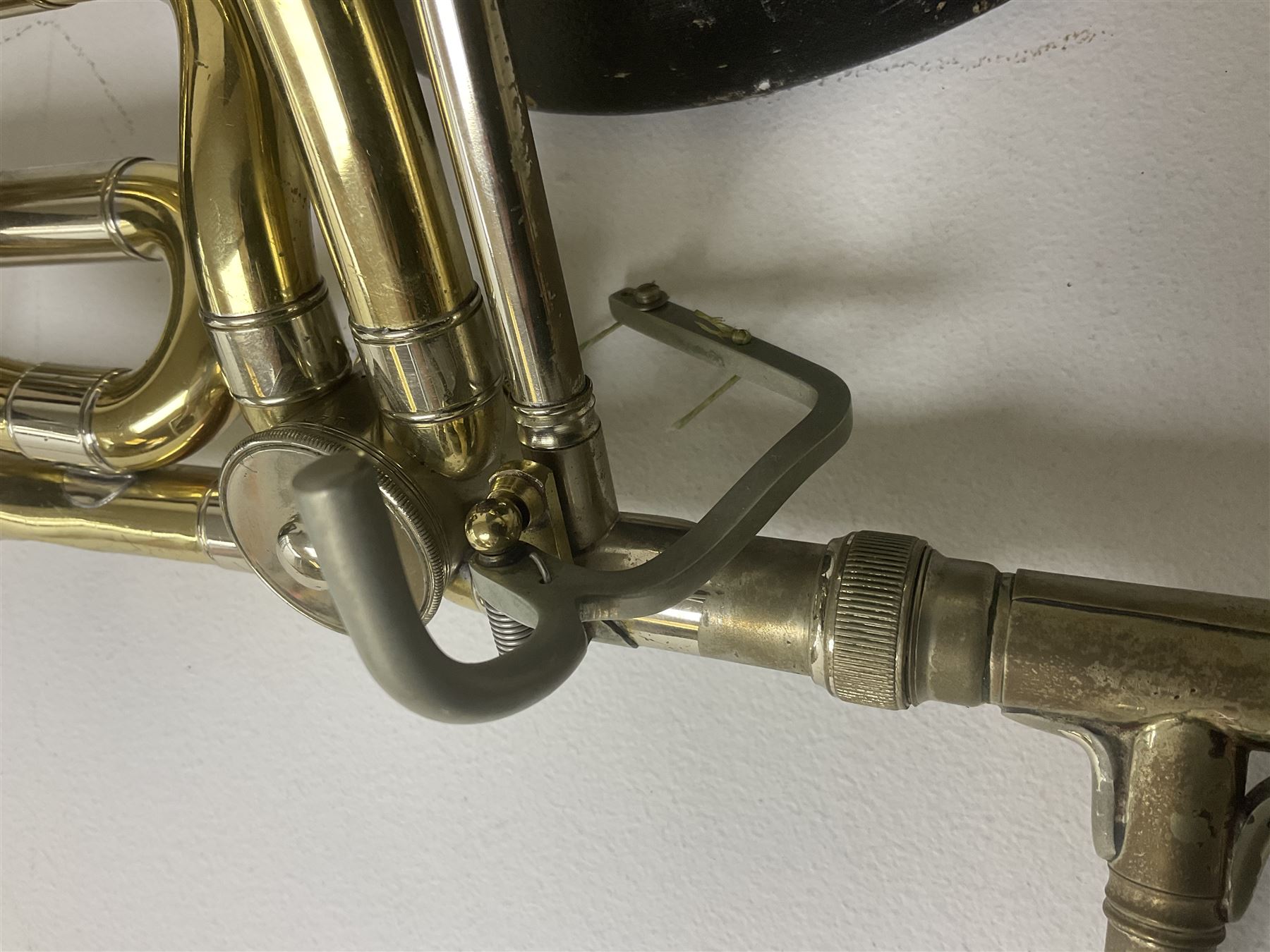 Three brass trombones comprising Elkhart Ind. USA 'CONN' model no.72H; Besson 'Concord'; and Selmer Distributed 'Lincoln'; two in carrying cases; and German B & M 'Champion' brass trumpet (4)