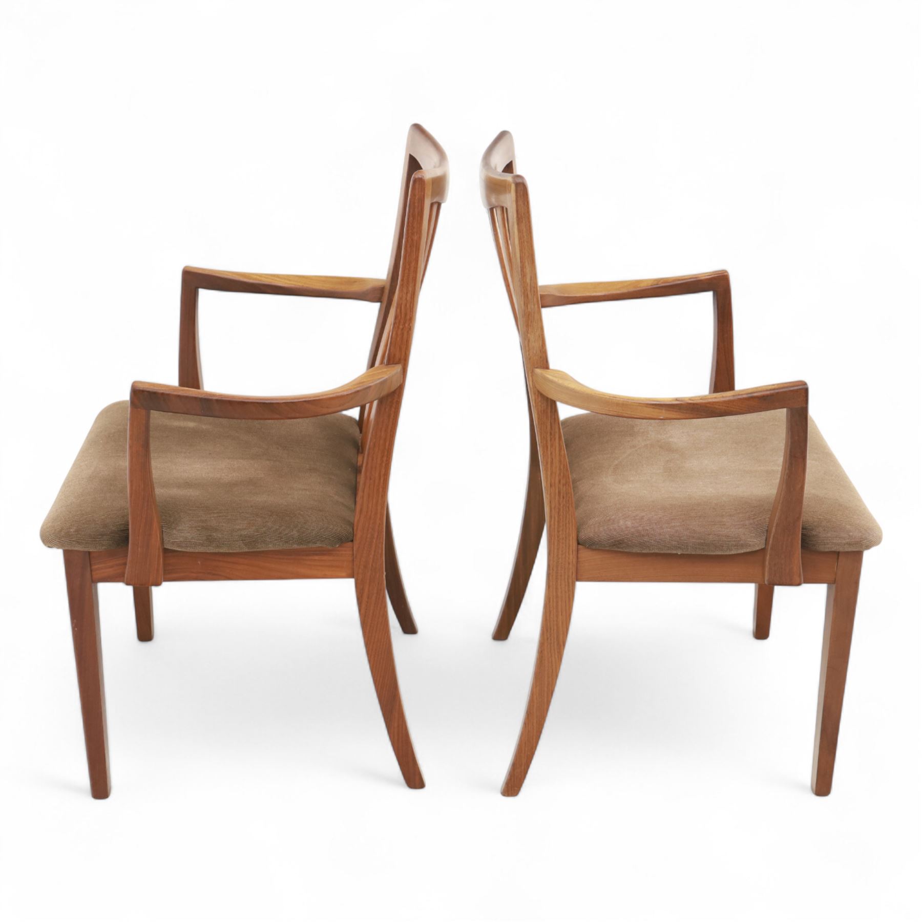 G Plan - mid-20th century teak extending dining table, oval top with integrated extension leaf, raised on tapering legs, together with a set of six slat back dining chairs including two carvers, upholstered in dark green velour (Extends to 210cm)