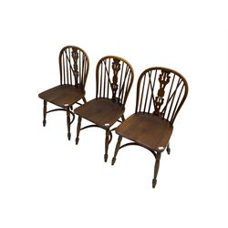 Late 20th century set three oak Windsor chairs, hoop and stick back with pierced and fretwork work splat, dished seat on turned supports joined by crinoline stretcher 
