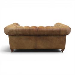 HALO - Chesterfield style two seat sofa upholstered in buttoned brown leather with stud work, on turned feet with castors