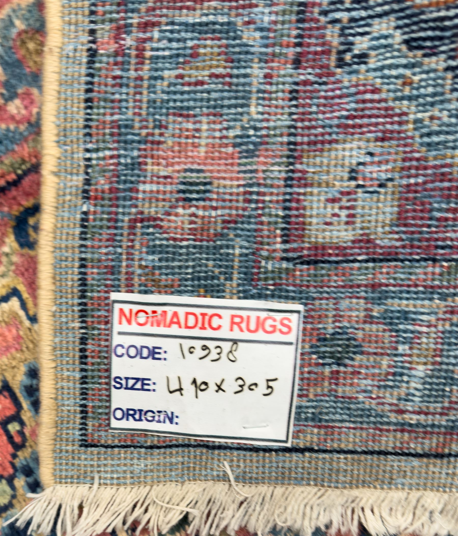 Northwestern Persian Meshkin hand-knotted carpet, the ivory field with an all-over design of scrolling vines and stylised floral sprays in burgundy, pink, and blue tones, enclosed by a raspberry red border of rosettes and palmettes linked by fine arabesques, from the region of Meshkin near Ardabil