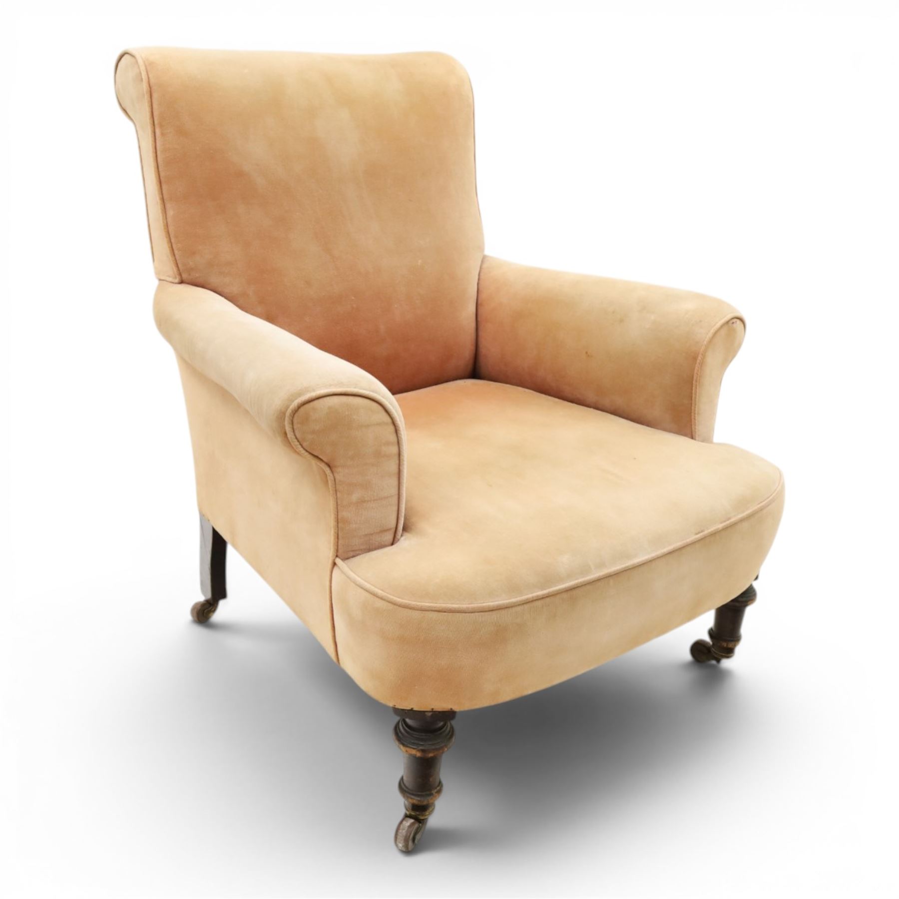 Victorian mahogany framed armchair of traditional shape, the high sprung rolled back over out-swept arms, deep sprung seat over turned feet with ceramic castors, upholstered in pale salmon pink fabric