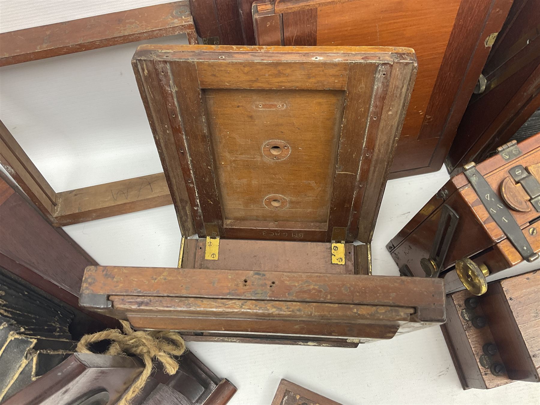 Collation of folding plate cameras of various sizes folding plate in mahogany and lacquered brass, together with camera plates and slides
By vendors repute some slide are from the Gandolfi workshop