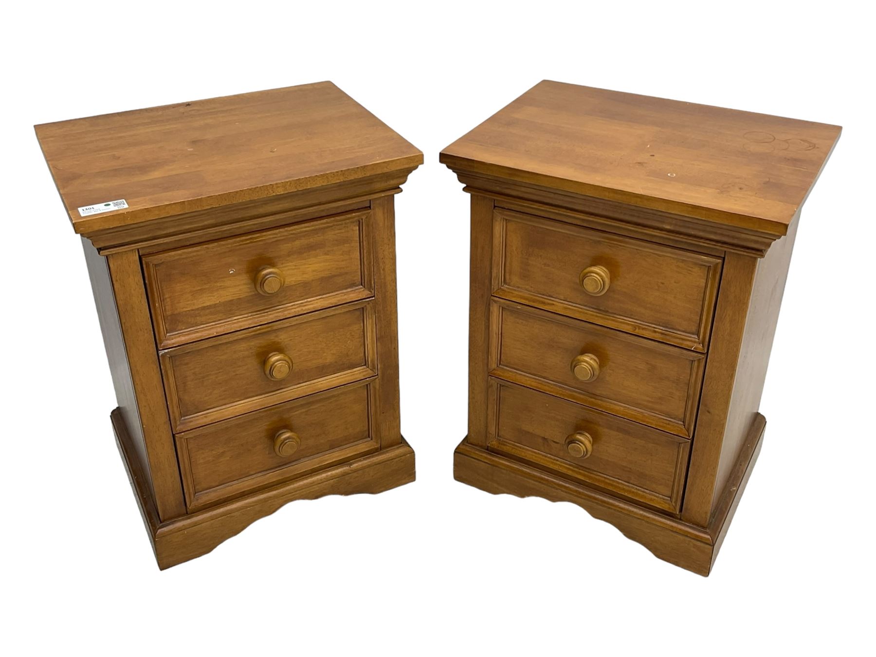 Pair of contemporary cherry wood bedside chests, rectangular top and projecting moulded cornice over three drawers, on plinth base with shaped apron