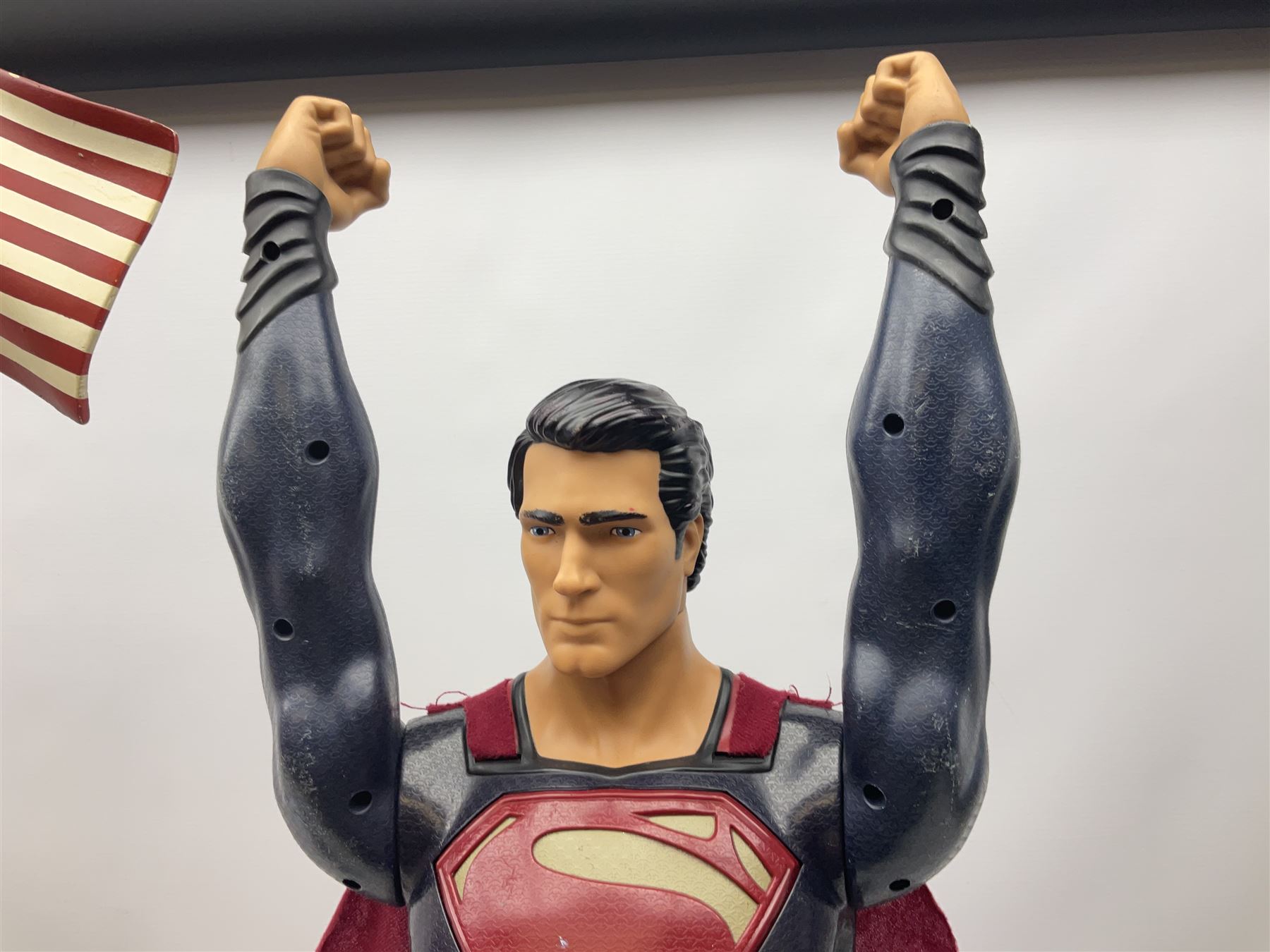Composite Superman with cape, together with a composite female statue holding the American flag, tallest example H103cm