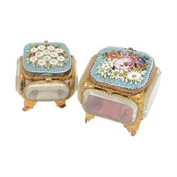 
Two Micro mosaic jewellery caskets with bevelled glass sides, the hinged lid decorated with raised flowers upon a blue ground, raised upon pierced gilt feet, largest H7cm 
