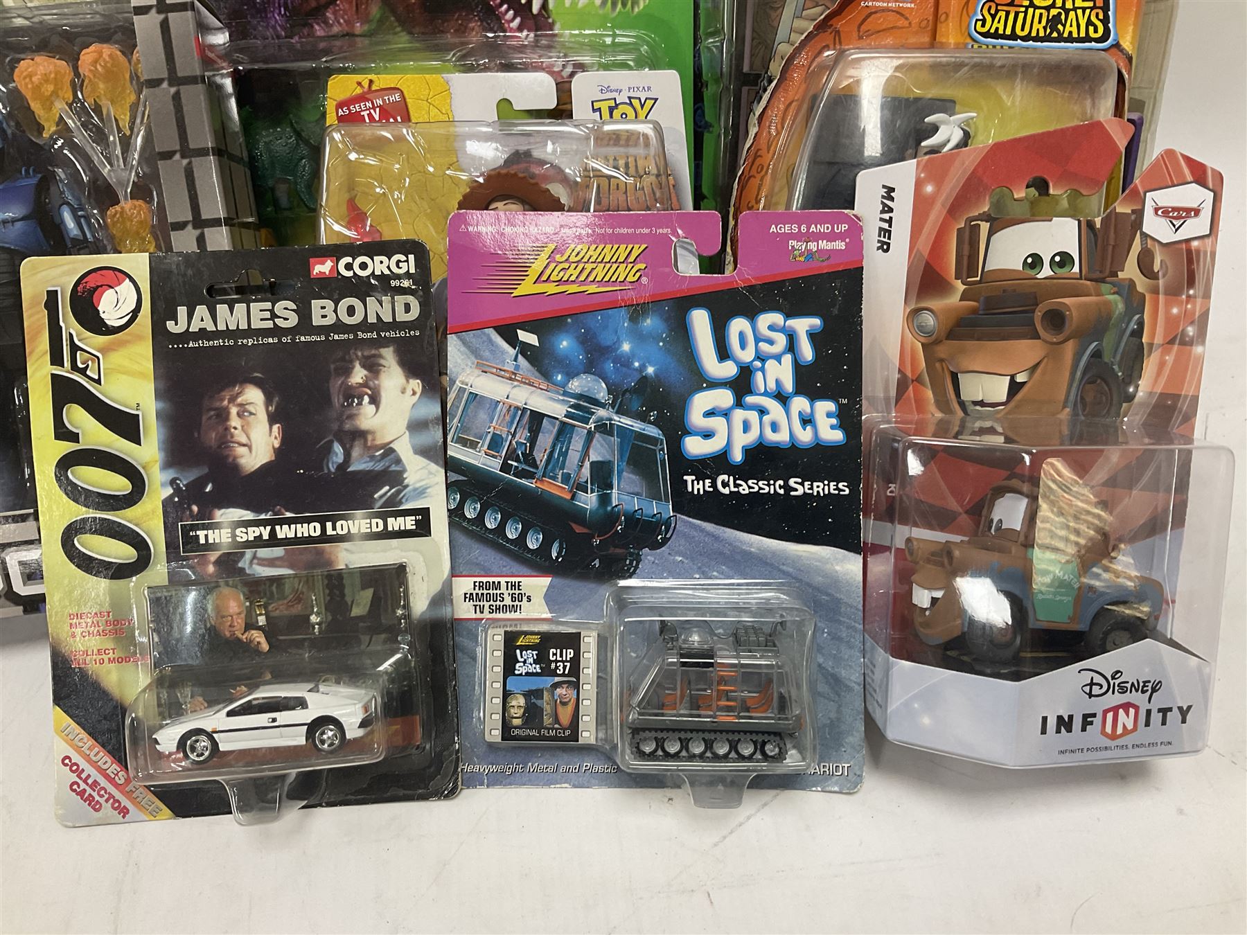 Fourteen carded action figures comprising Toy Story, X-Men Marvel Legends, Lord of the Rings, The Lost World Jurassic Park (2), The Secret Saturdays, Wallace & Gromit, Corgi Tom & Jerry (4), Flintstones, Lost in Space and Disney Infinity Cars; all in unopened blister packs; together with two boxed Robocop figures and carded James Bond car (17)