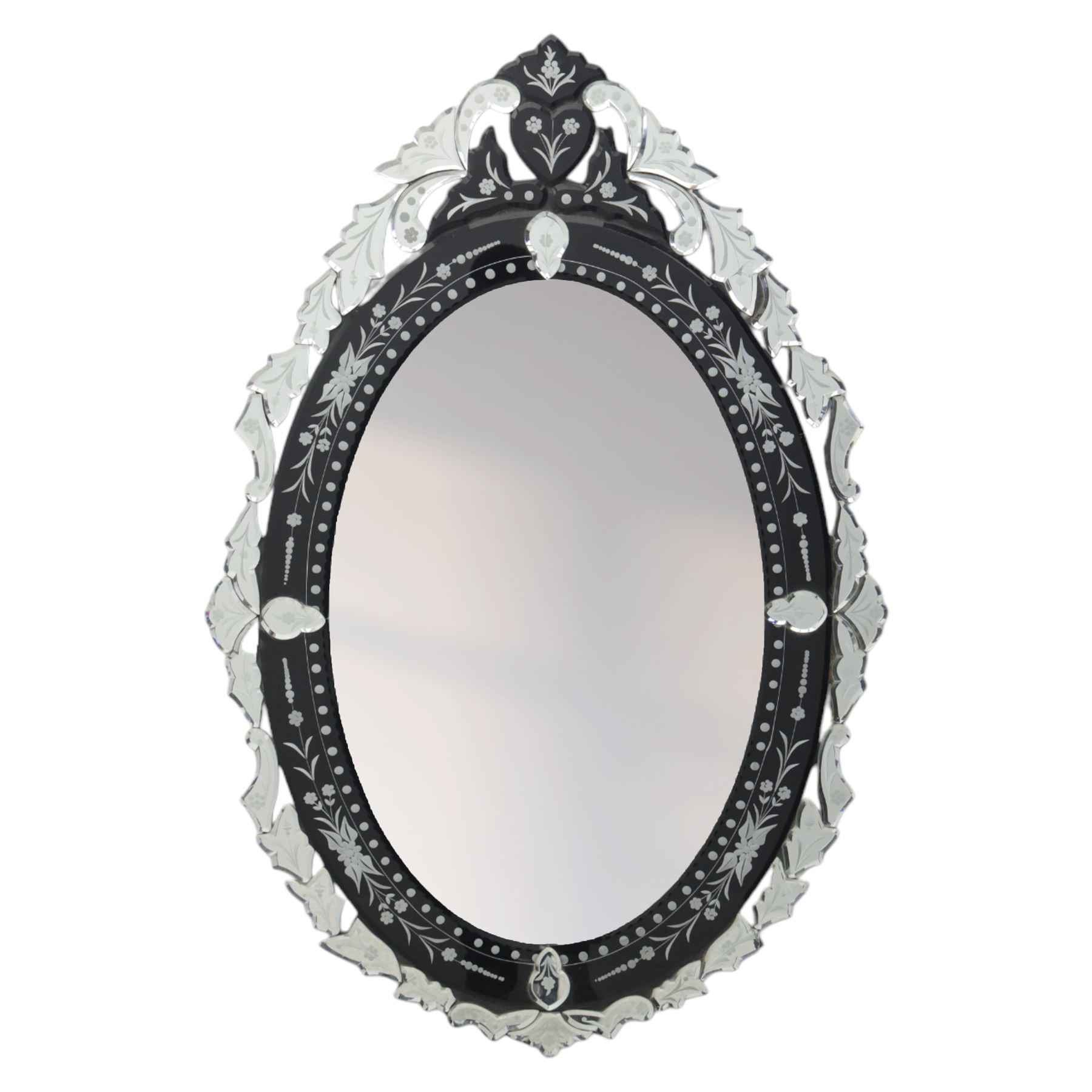 20th century Venetian style oval mirror, the central mirror plate enclosed by an ebonised border decorated with engraved floral trails and dotted reserves, the outer edge applied with shaped and etched glass leaves and scrolling foliage