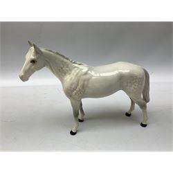 Collection of Beswick horses, including grey horse no.701, palomino foal no 836, grey stocky jogging mare no.855 etc, together two Royal Doulton horses, (8)