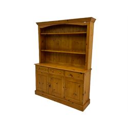 Polished pine farmhouse dresser, fitted with three drawers and three cupboards, with plate rack 