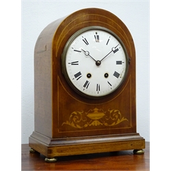  Edwardian inlaid mahogany arched top mantel clock with white Roman dial, twin train movement striking the half hours on a coil, brass bun feet, H34cm  