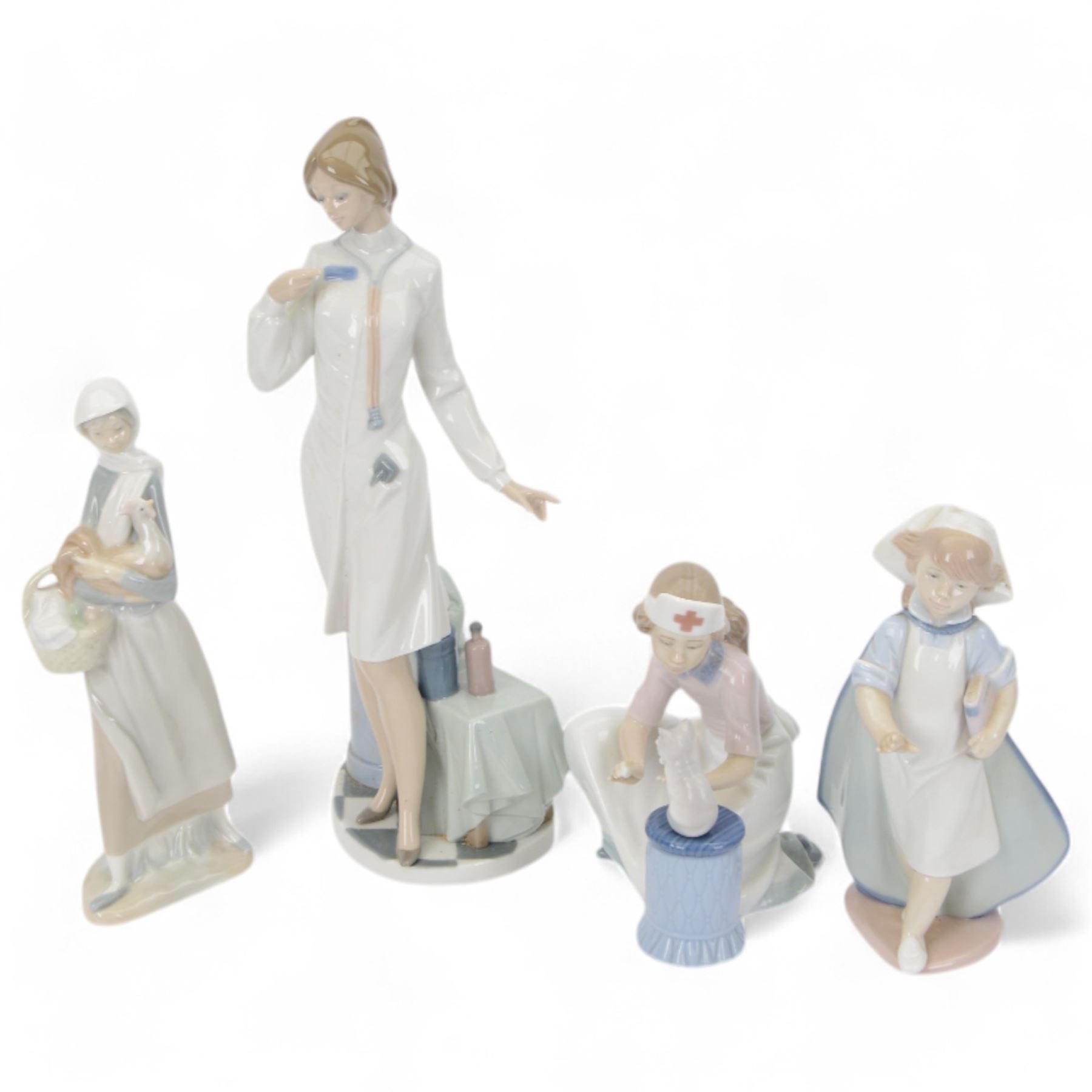 Four Lladro figures, comprising Loving Care no 6087, Young Nurse no 6307, Girl with Chicken no 4592 and Female Physician no 5197, three with original boxes 