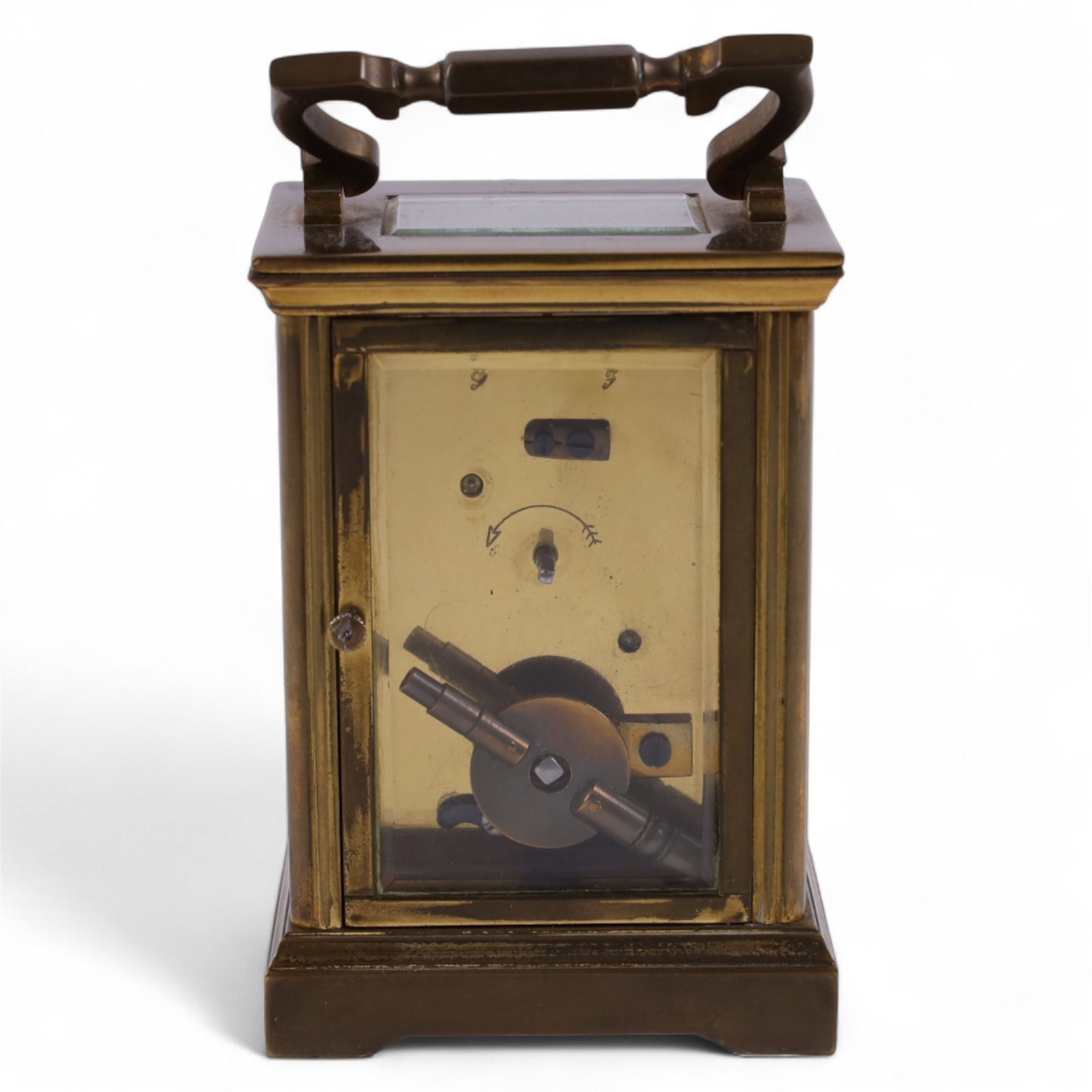 French-Early 20th century 8-day corniche carriage clock with a replacement lever platform escapement, enamel dial with Roman numerals and retailers name 