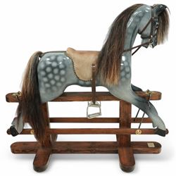 Wooden rocking horse, in Dapple Grey paint finish with reins and stirrups, on pine trestle base, metal plaque inscribed 'Hoppringle Horses by J. J.V. Eyre Hoppringle by Stow, Galashiels TD1 2TJ'