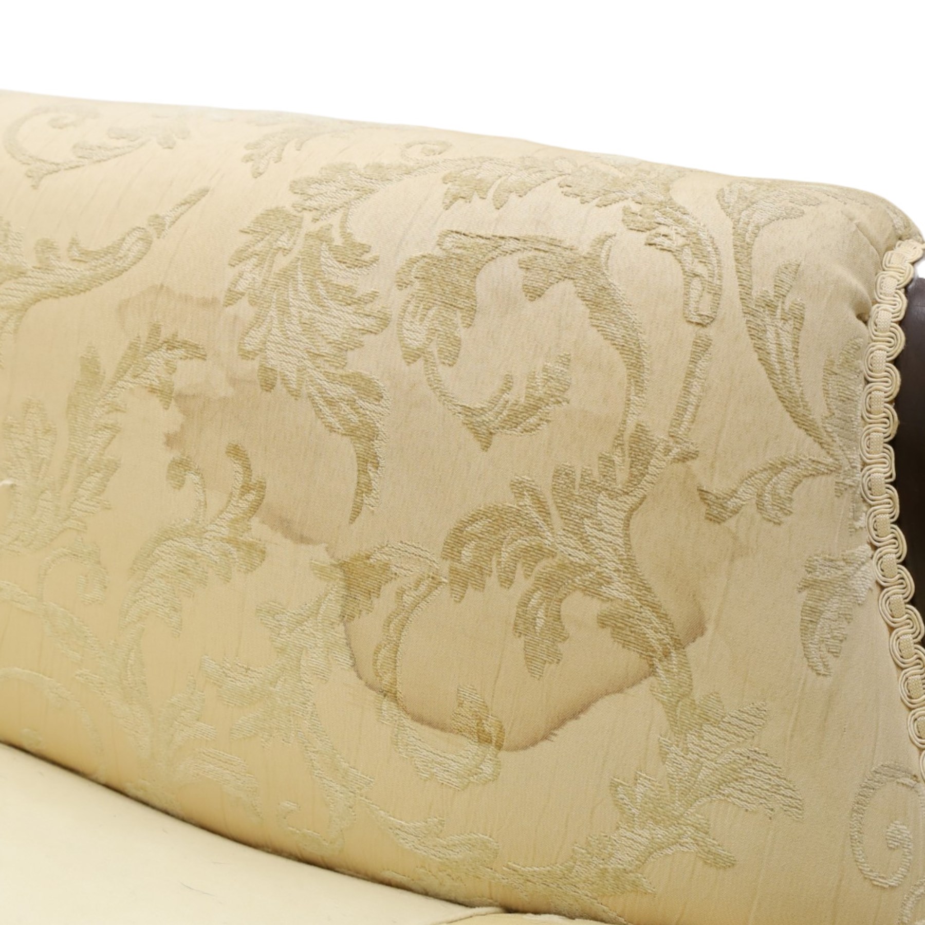 Quality Edwardian carved mahogany lounge suite comprising three-seater settee and pair of armchairs, the sofa with arched back over rolled arms and deep sprung seat, the arm terminals carved with acanthus rosette over gadroon and rope-twist moulding, the shaped apron carved and moulded with scrolling foliate acanthus motifs, terminating to four large front hairy paw and ball feet, upholstered in pale yellow foliate fabric with matching seat and scatter cushions (W200cm D105cm H73cm); the matching deep armchairs (W78cm D95cm H75cm)