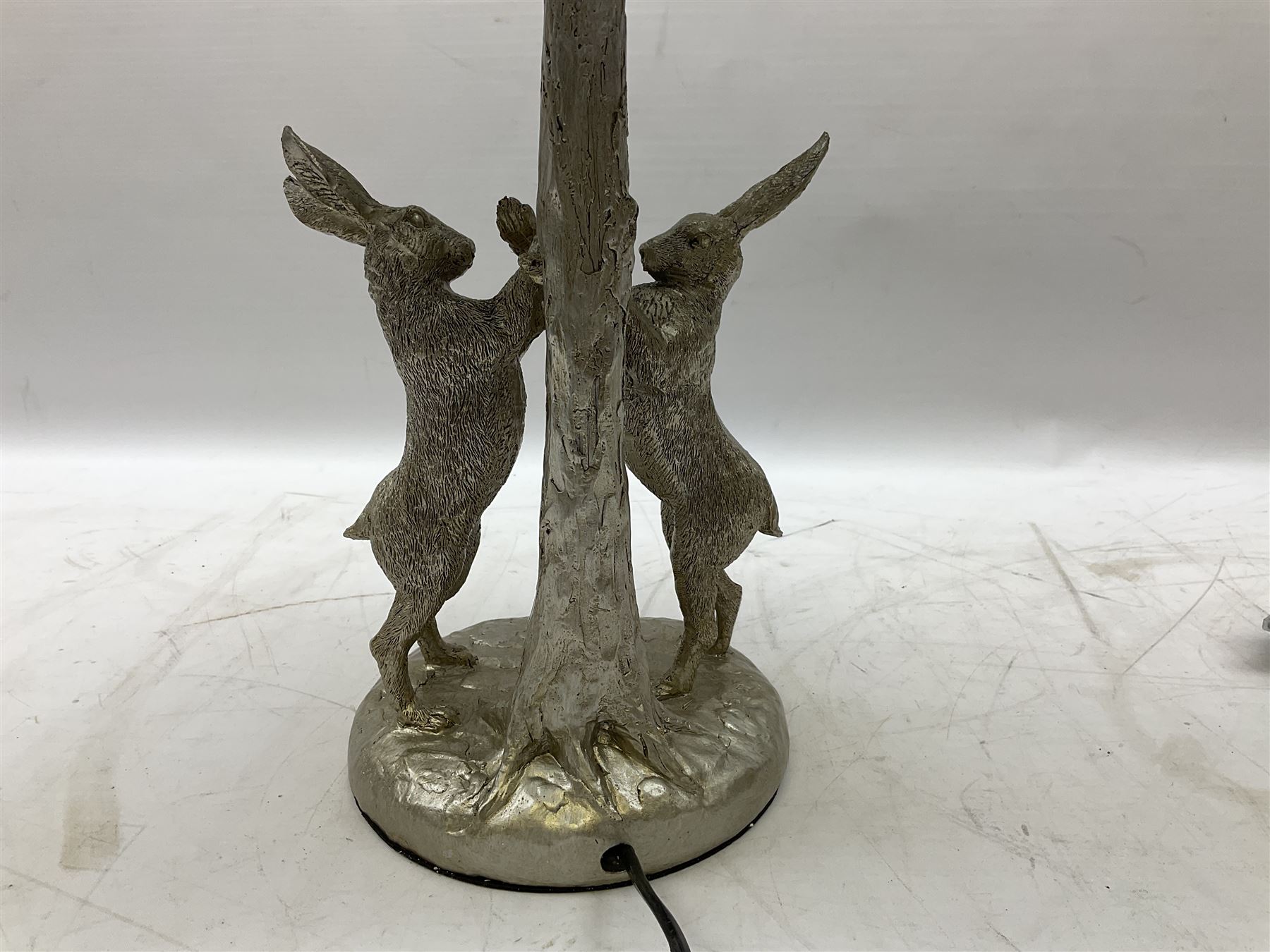 Silver composite table lamp, modelled as a pair of boxing hares, with a grey velvet shade, H45cm