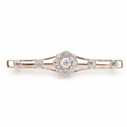 Early 20th century gold and silver diamond brooch, the flower head cluster set with nine old cut diamonds, to split design shoulders, either side set with two further diamonds, total diamond weight approx 1.25 carat