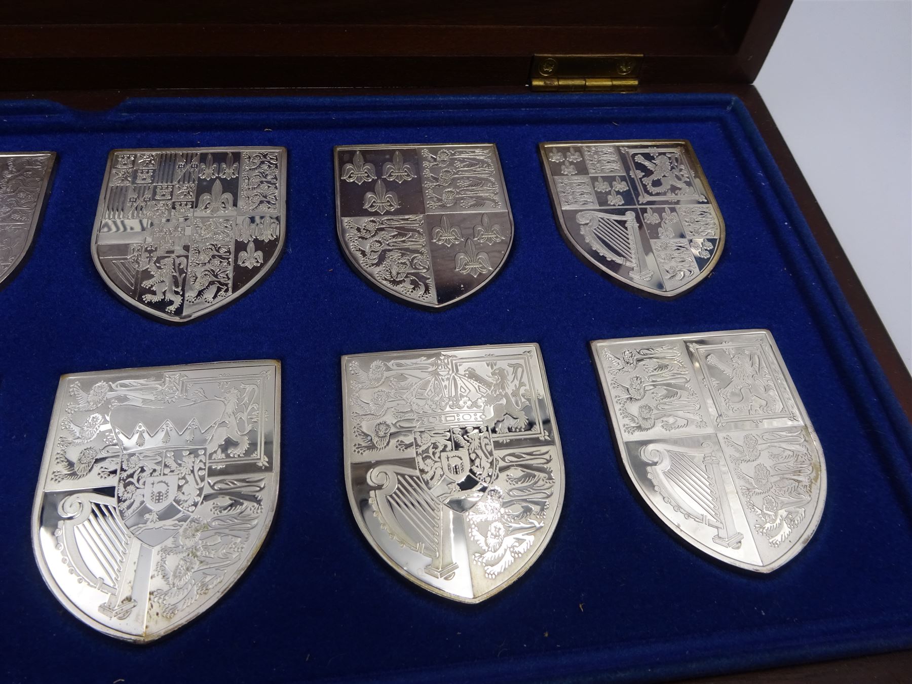 Yorkshire Mint, The Royal Arms Collection, twelve shield shaped silver medallions each depicting variations on the Royal coat of arms, each hallmarked Yorkshire Mint, Birmingham 1976/77, contained within fitted wooden case with associated information cards