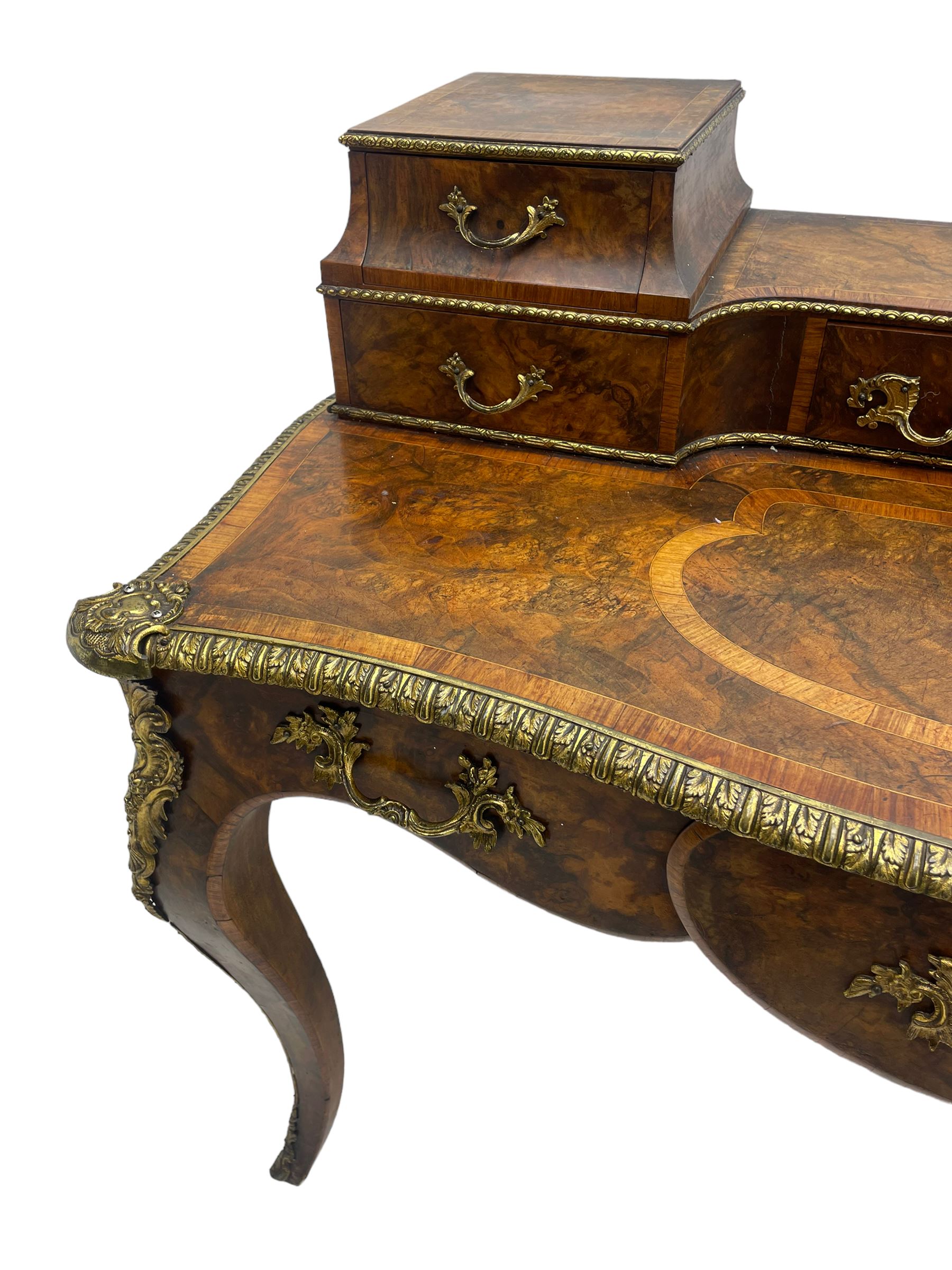 Late 19th to early 20th century French figured walnut writing desk, raised back fitted with drawers, shaped top with Kingwood banding and foliage cast edge moulding, fitted with single drawer, on cabriole supports mounted by shell and flower head cartouches 